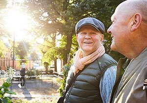 Two retired men talking in park